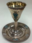 A Judaica silver goblet on stand set with blue stones.