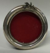 A silver frame cast with flowers.