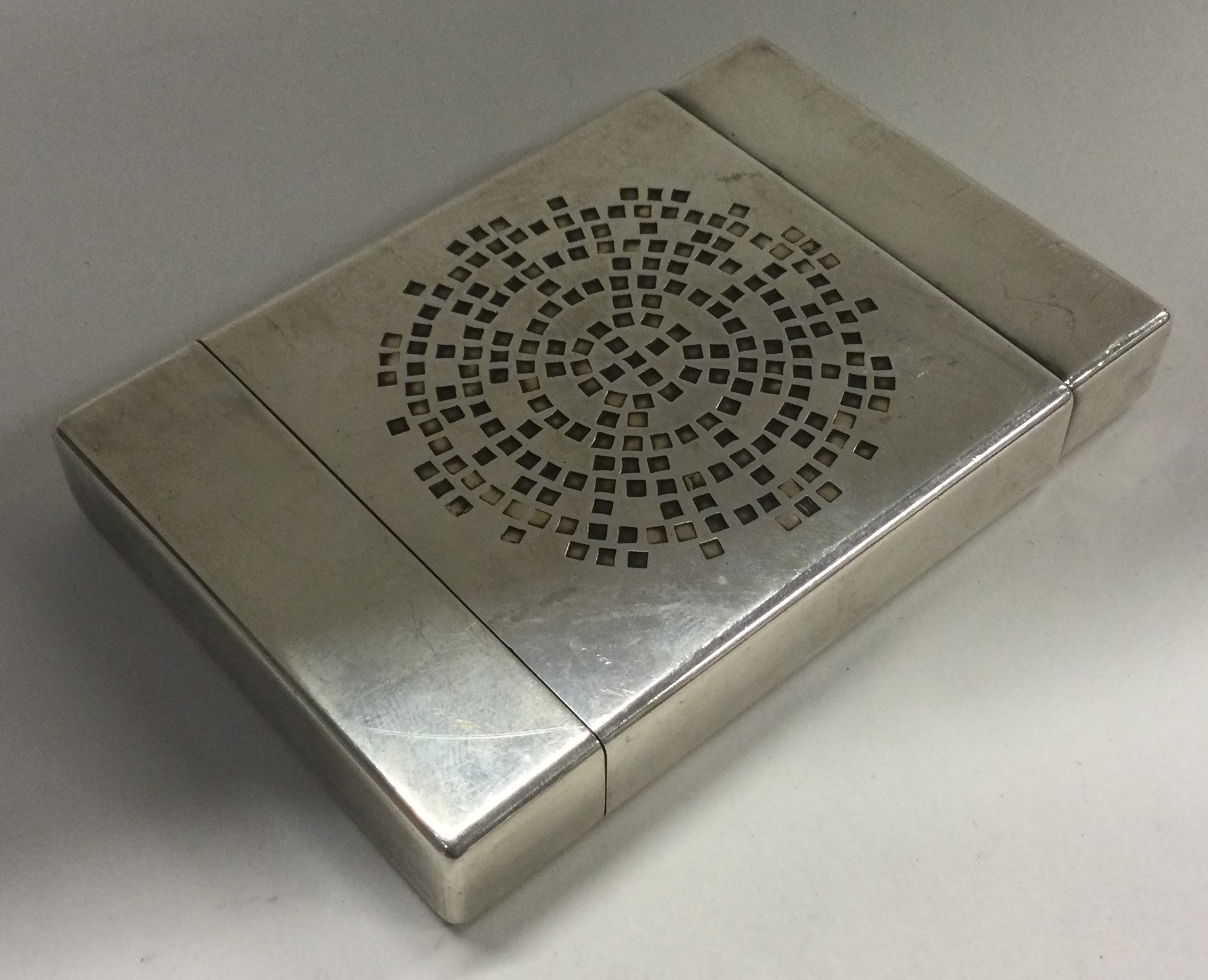 An unusual silver card case with lift-off cover.