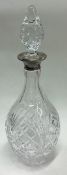 A large silver and glass decanter with stopper.