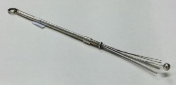 A silver collapsible swizzle stick.