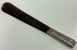 A tortoiseshell shoe horn.