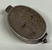 A good novelty oval silver box in the form of a mask with spring mount to gilt interior.