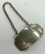 A good Georgian silver wine label of shaped form for 'Gin'.