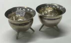 A rare pair of Victorian silver cauldron shaped salts on three feet.