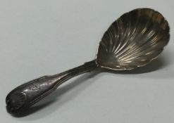 A Georgian silver caddy spoon with fluted bowl.