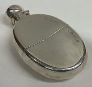 A Victorian silver flask with detachable cover.