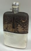 A large Victorian silver mounted glass and leather flask with screw-top lid.
