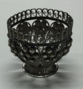 A filigree silver egg cup.