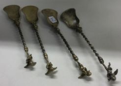 A set of four silver figural ice cream spoons.