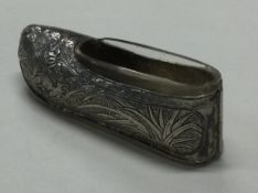 An early 20th Century Chinese export silver shoe with clear glass liner.