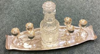 A good silver liqueur set on stand with large cut glass decanter.