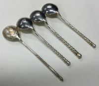 A set of three 19th Century Russian silver and Niello spoons together with one other.
