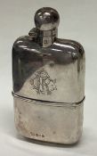 A good quality silver hip flask with detachable base to hinged lid.