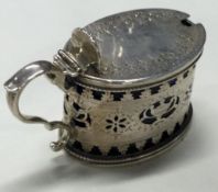 A Victorian silver mustard pot with pierced decoration.