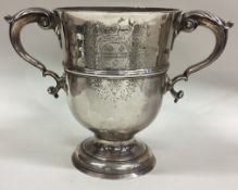 A large 18th Century Provincial silver two-handled cup with central armorial.