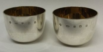 A pair of Britannia Standard silver tumbler cups with gilt interiors.