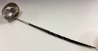 A large 19th Century silver toddy ladle with coin to centre.