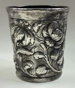 An 18th Century Scandinavian silver beaker embossed with flowers.