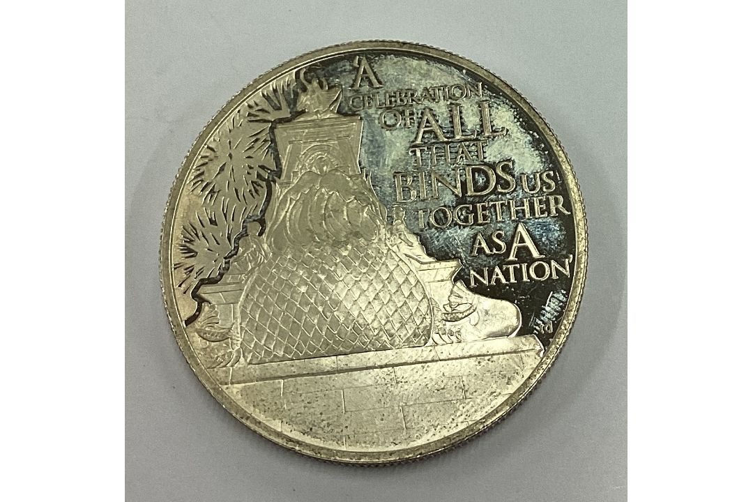 A silver Elizabeth II Five Dollar coin. - Image 1 of 2