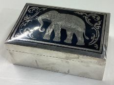 A silver and Niello jewellery box with lift-off cover and elephant decoration.
