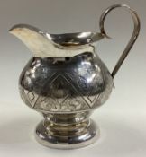 A 19th Century Russian silver jug with chased decoration.