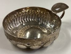 An early 19th Century silver wine taster.