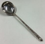 A heavy Russian silver spoon with engraved decoration.
