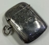 A silver vesta case with engraved decoration.