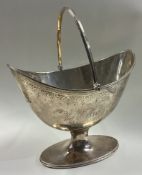 An 18th Century silver swing handled basket with bright-cut decoration.