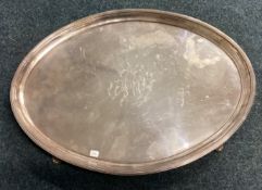 A large 18th Century oval silver salver on feet.