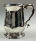 An 18th Century silver tankard.