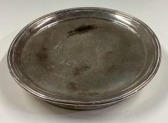 A heavy early Victorian silver teapot stand with central amorial.