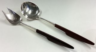 A fine pair of Art Deco silver salad servers with wooden handles in the style of Georg Jensen.