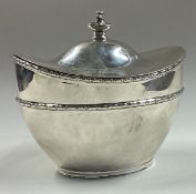 A silver tea caddy / biscuit box with hinged lid.