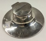 A silver inkwell.