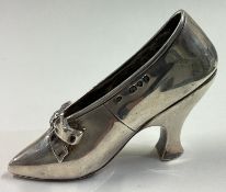 A heavy Victorian silver model of a shoe.