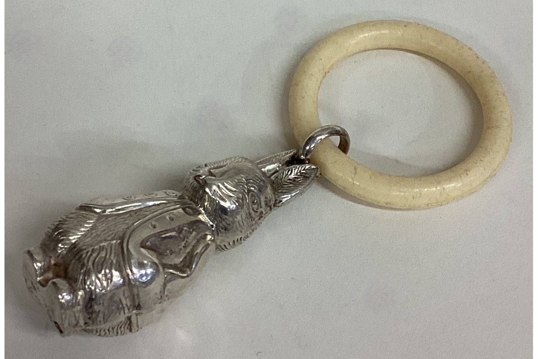 A small modern silver rattle in the form of Peter Rabbit.