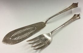 A pair of silver fish servers.