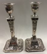 A pair of Neoclassical silver candlesticks in the Georgian style.