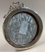 An ornate silver photo frame with swag decoration.