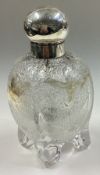 A Victorian silver and glass perfume bottle on feet.