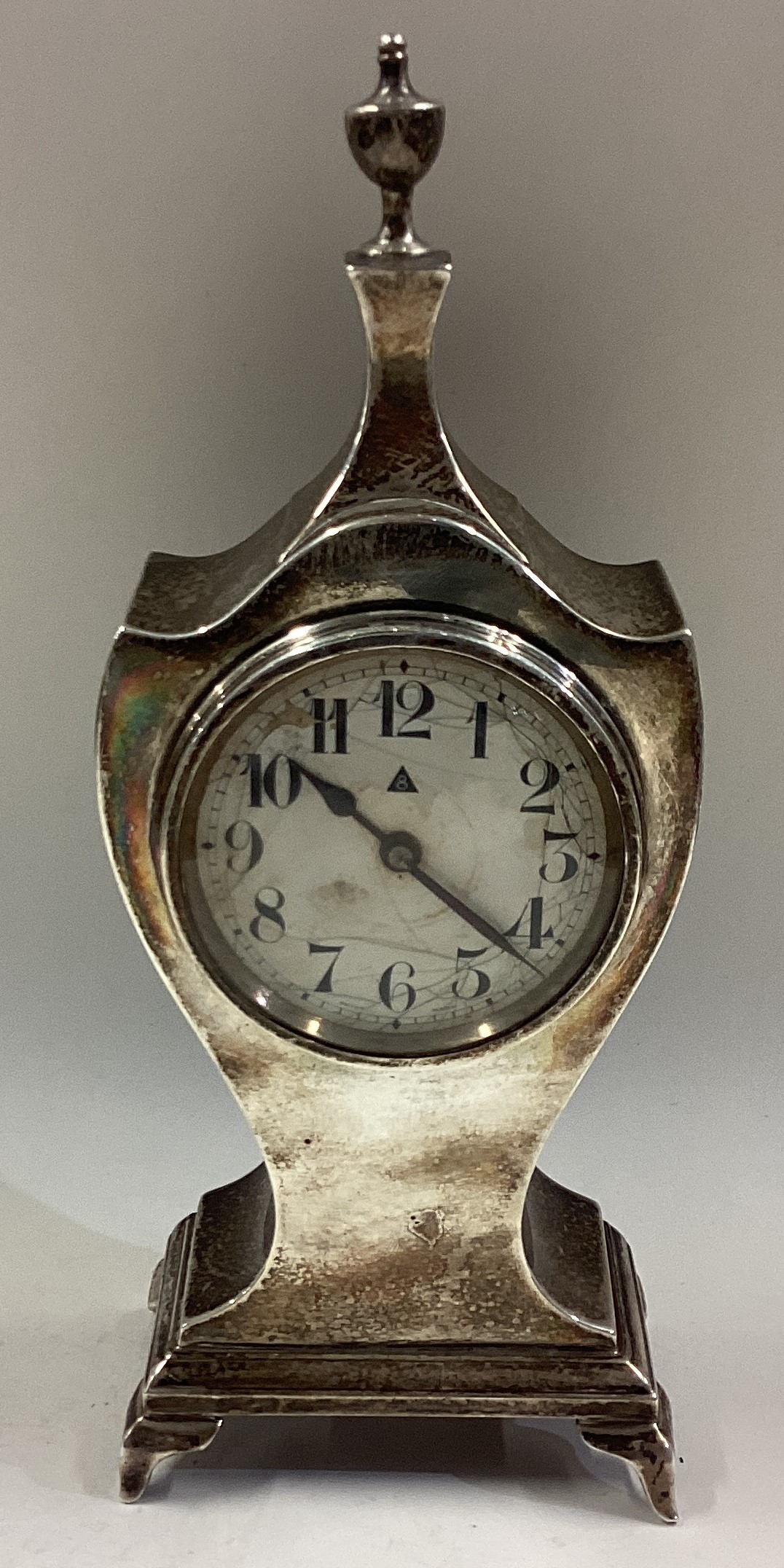 A large silver clock on feet.