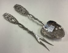 A Judaica silver leaf vine spoon and fork with chased menorah decoration.