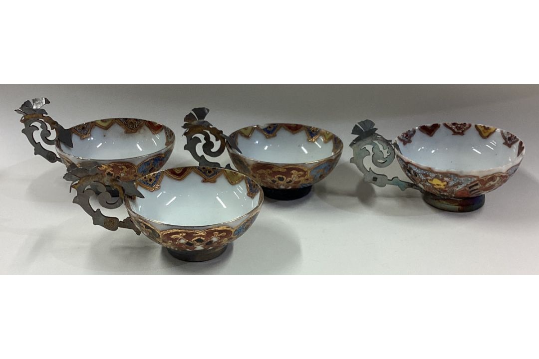 A set of four silver mounted cups with pierced handles. - Image 1 of 2