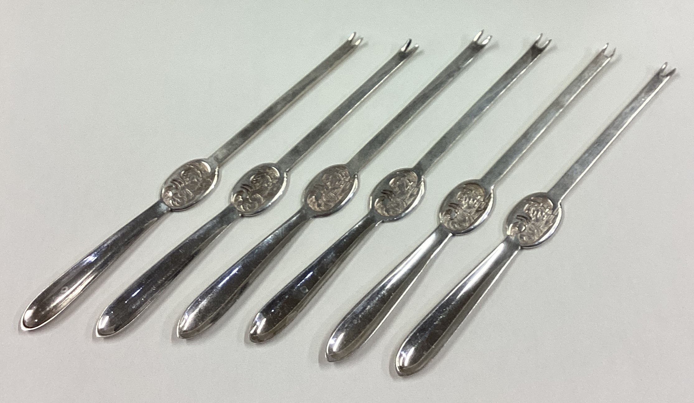 A set of six silver plated lobster picks.