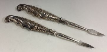 Two silver handled picks.