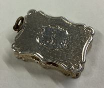 A small hinged top silver vinaigrette with gilt interior.