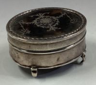 A silver and tortoiseshell jewellery box.