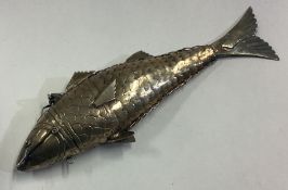 An articulated silver figure of a fish.
